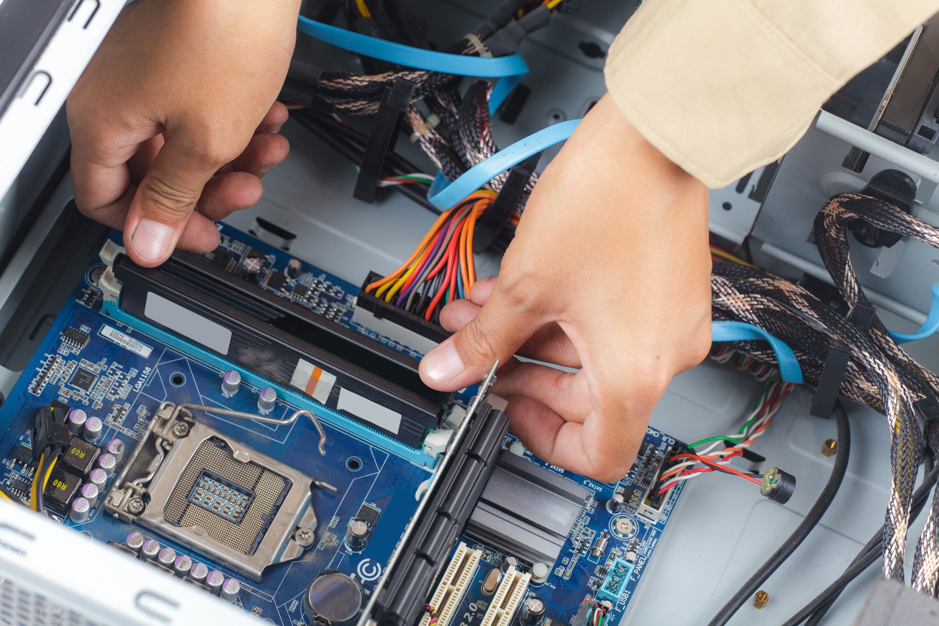 Hands installing components inside a desktop computer