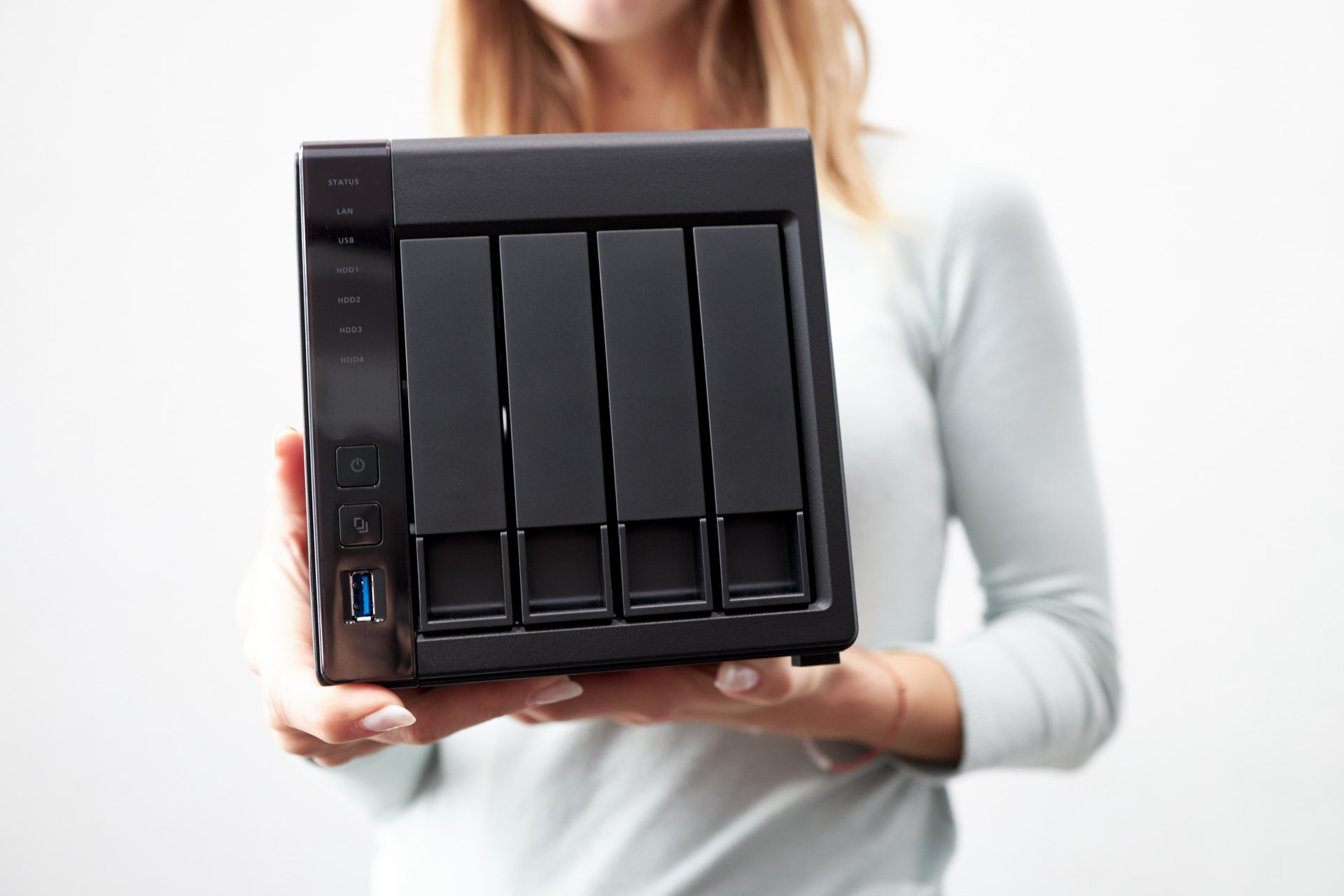 Person holding a four-bay storage enclosure