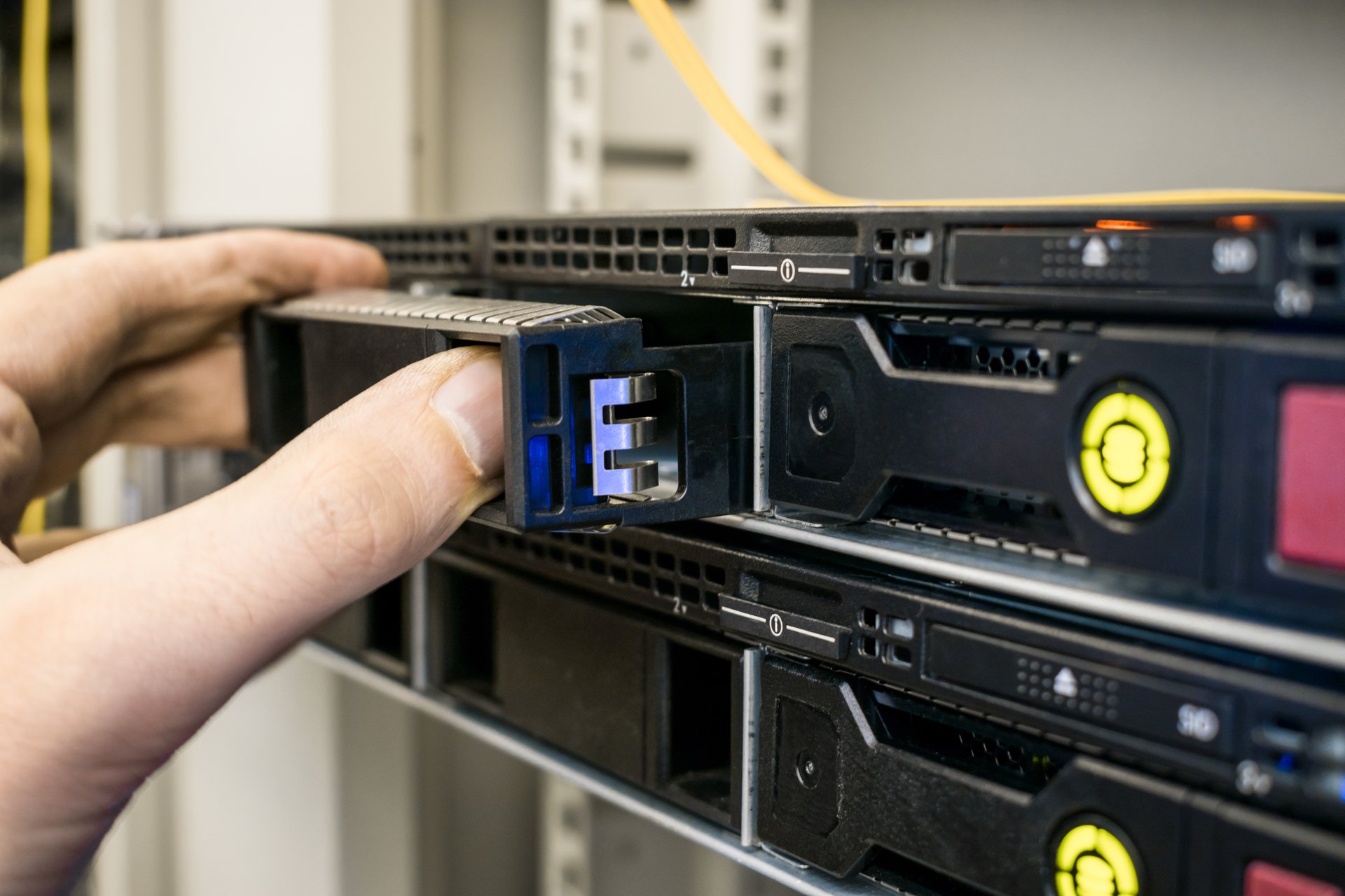 Hands working on a removable server drive