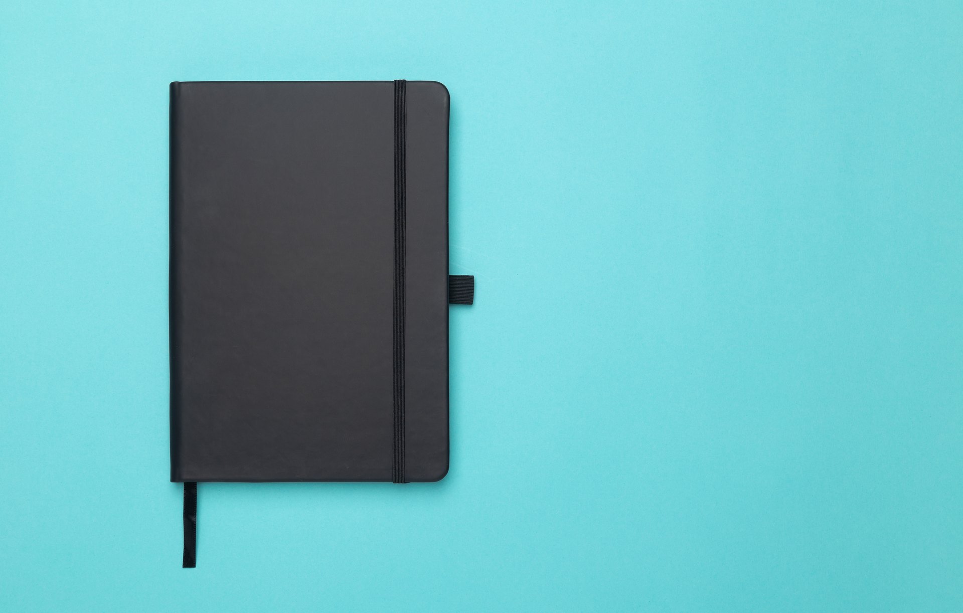 Closed notebook on a blue background