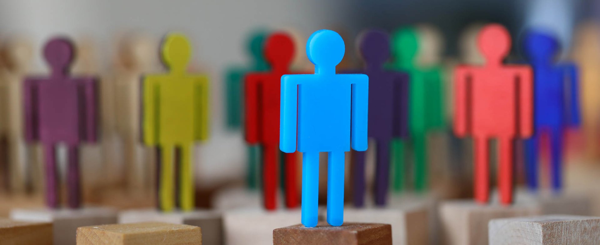 Colorful human-shaped figures arranged in a group