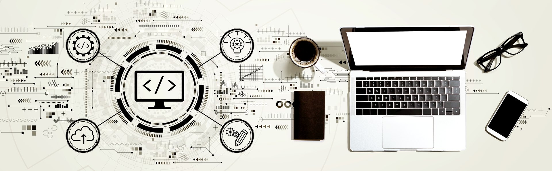 Laptop and desk accessories with software-development symbols