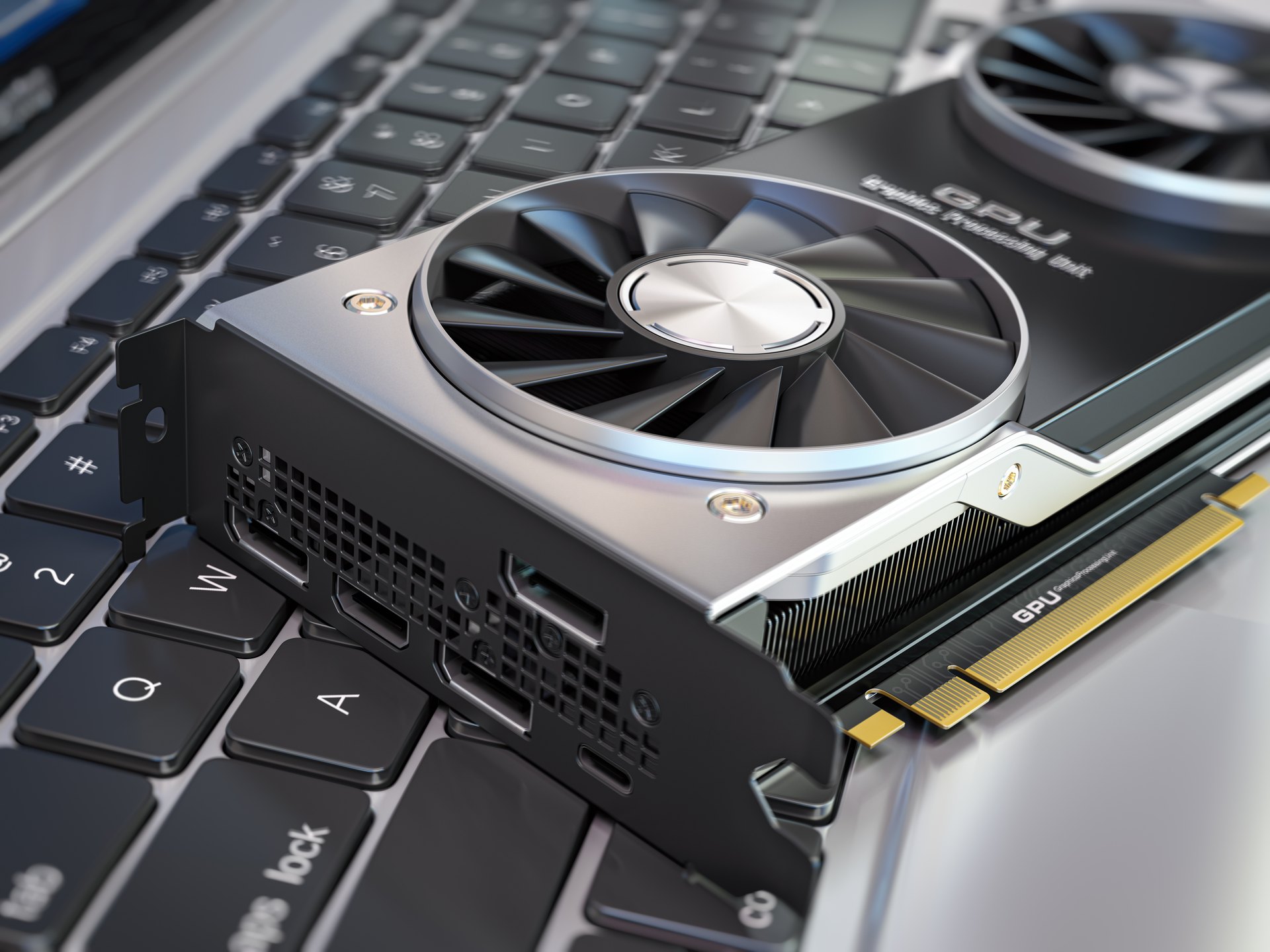Illustration of a graphics card beside a laptop keyboard