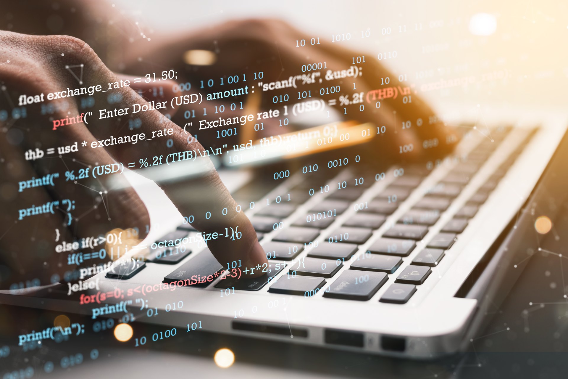 Hands typing on a laptop with a programming overlay