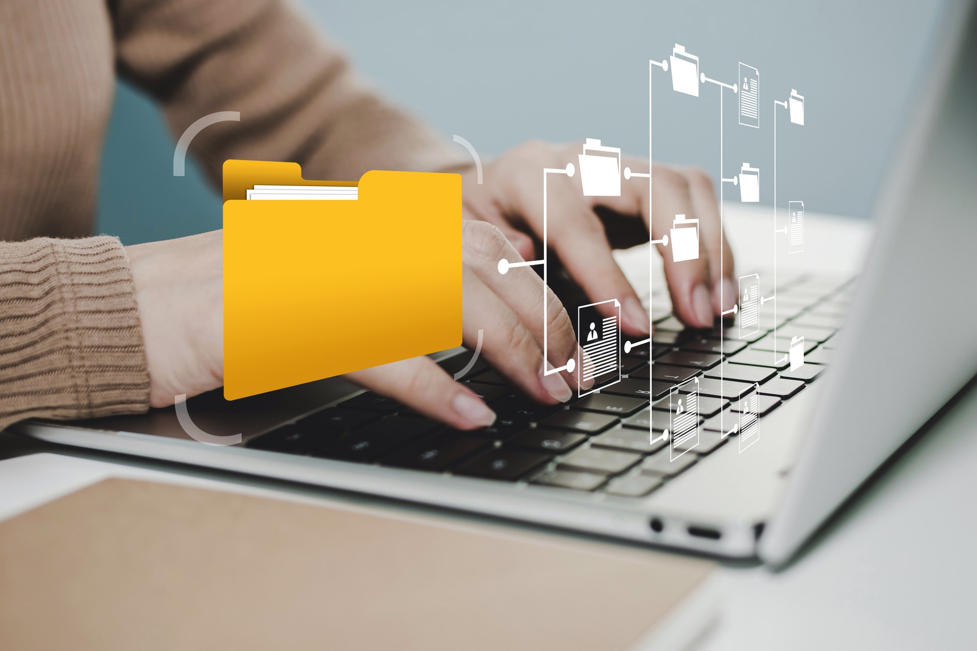 Person using a laptop beneath a folder illustration