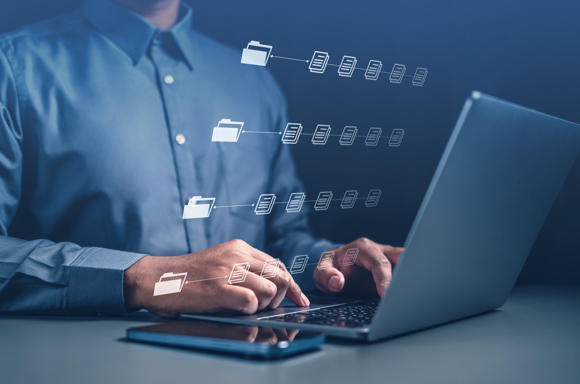 Person working at a laptop with document organization symbols